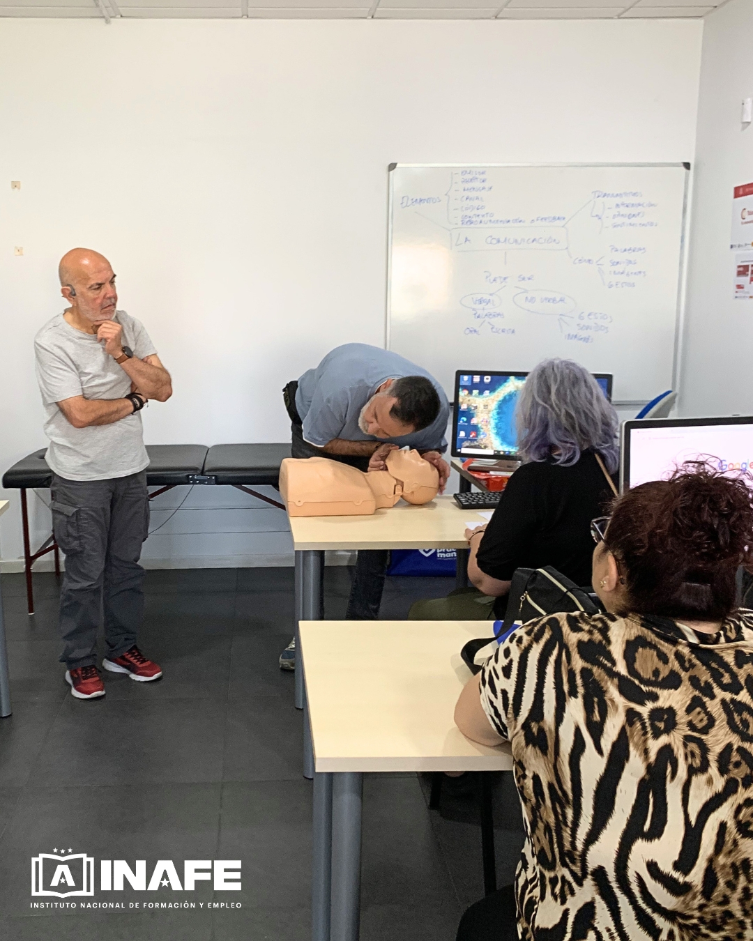 Instructor realizando RCP en un maniqu&iacute; ante alumnos en formaci&oacute;n para el empleo