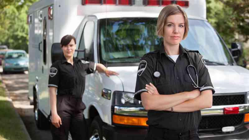 Dos técnicas de emergencias junto a una ambulancia, formación para el empleo