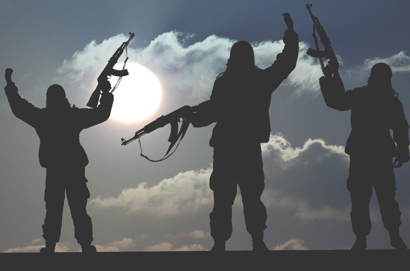 Tres siluetas armadas con fusiles alzados frente al sol, formación para el empleo