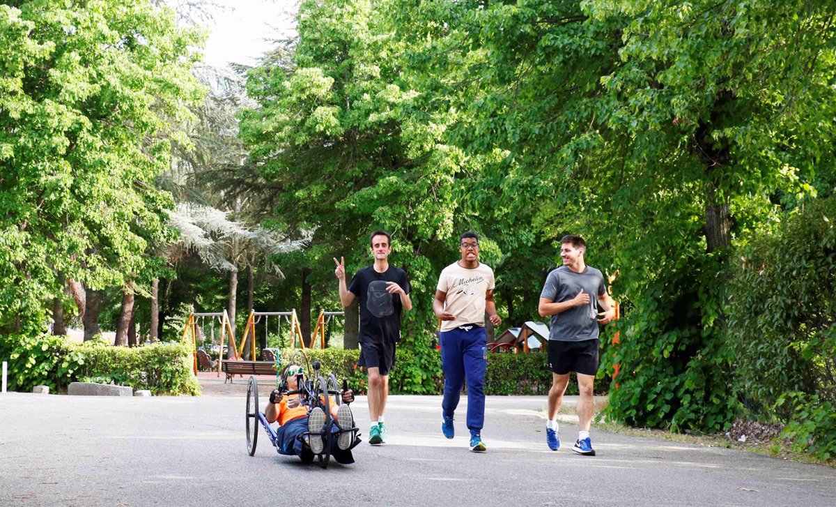 Deportista en handbike y tres corredores en un parque, formación para asociaciones