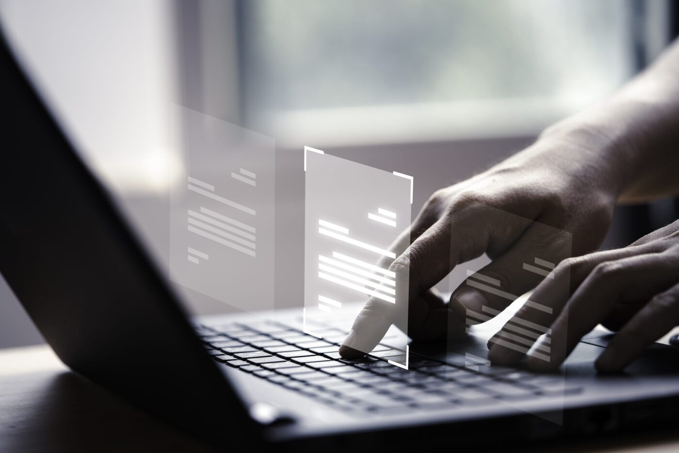 Manos tecleando en un portátil con documentos virtuales, cursos online